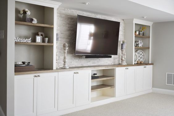 white living room cabinetry with wood open shelving