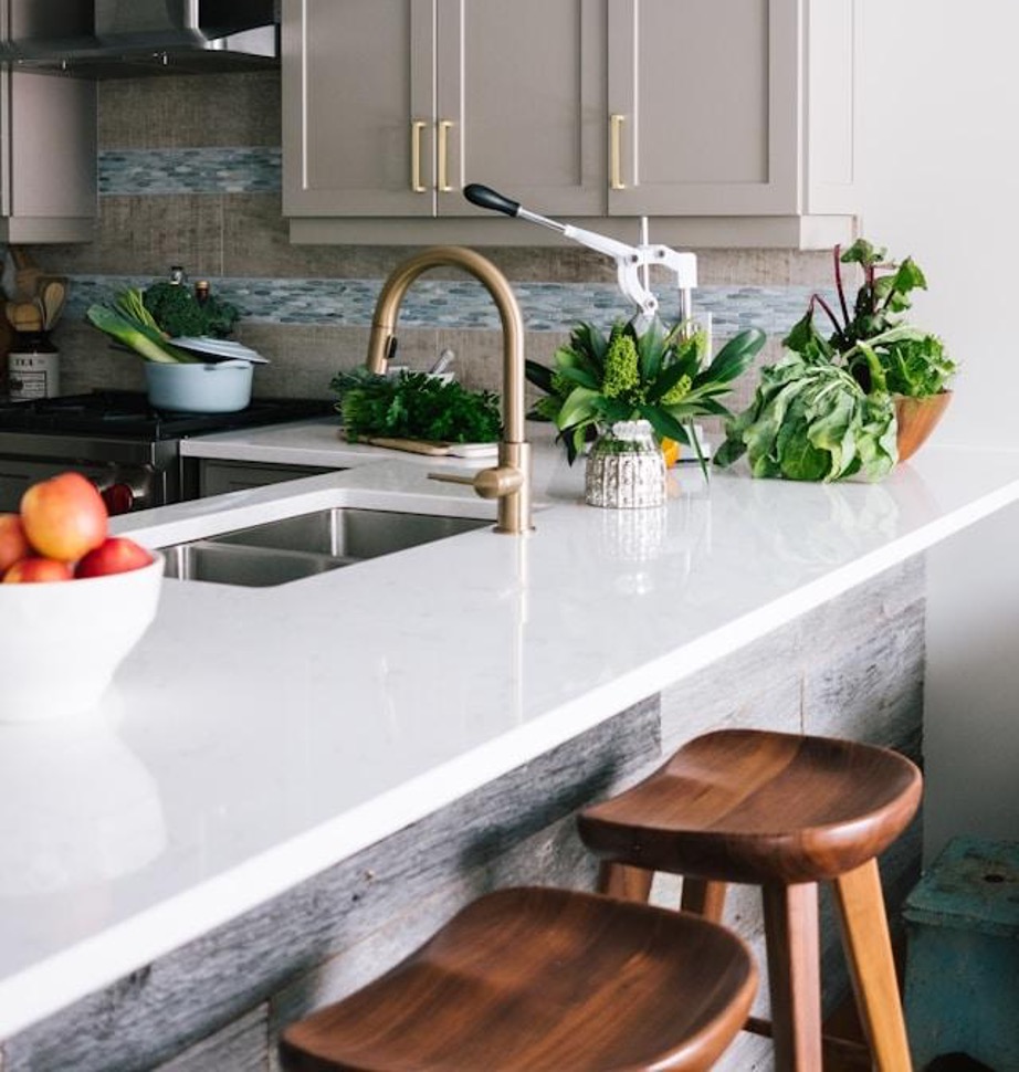 light and airy kitchen design with gold faucet 